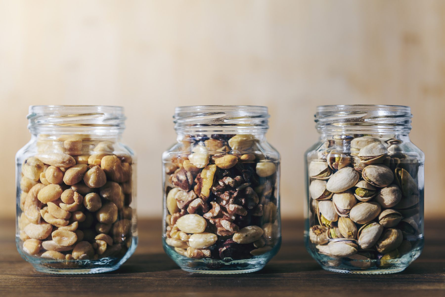 three glass jars with mixed nuts and dried fruits Detroit Office Pantry