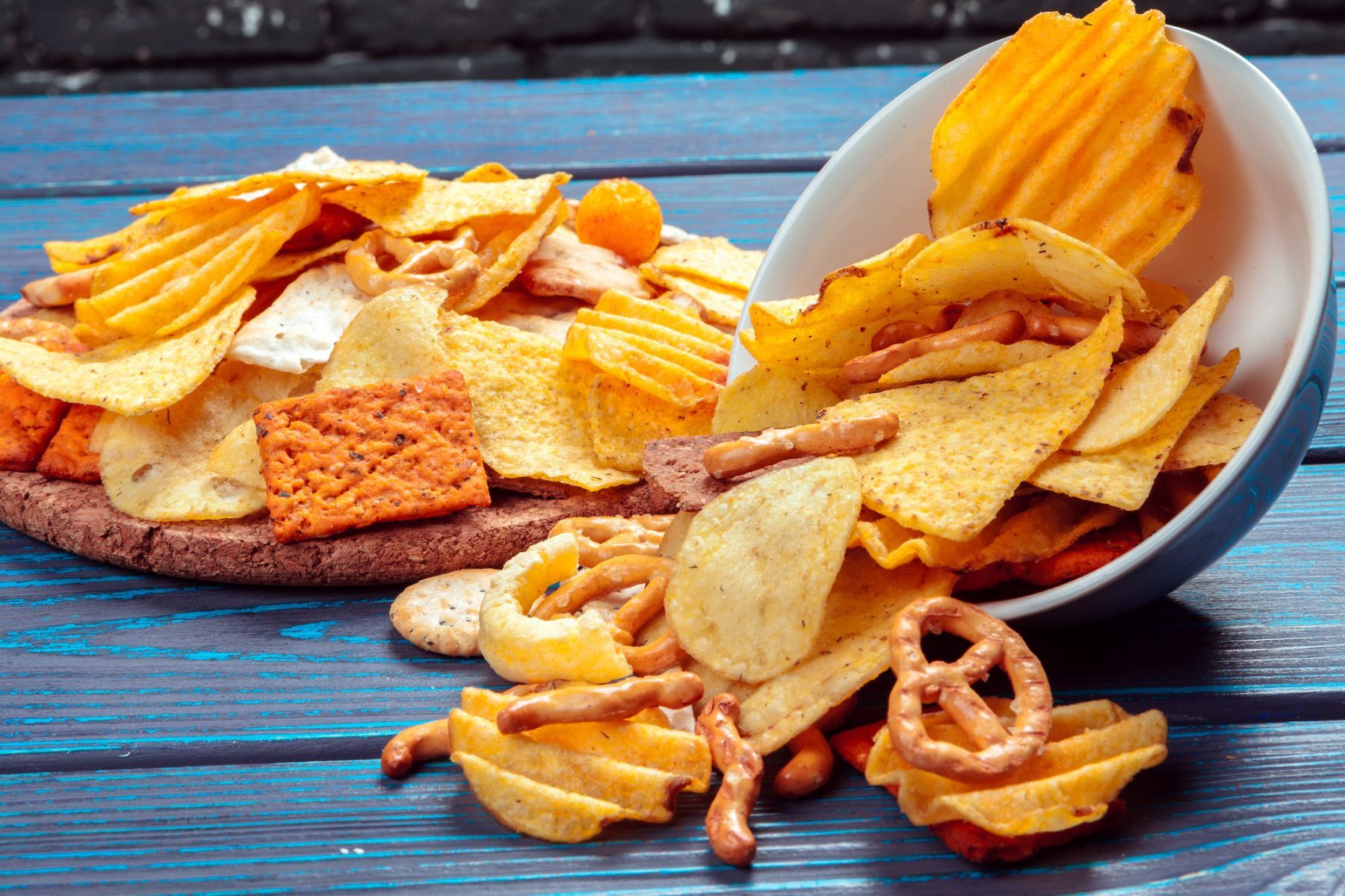 Differnt Types of Junk food, salty-sticks, salty-crackers on wooden table in still-life Quebec City Vending Machines