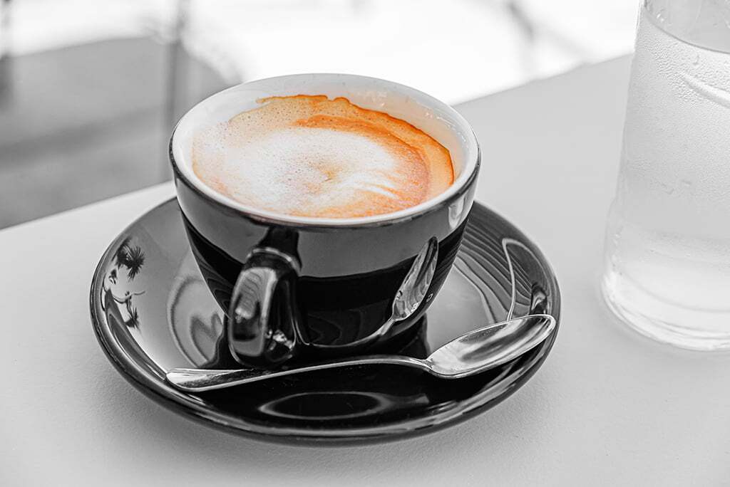 Cup of aromatic black coffee on a wooden background. Memphis office coffee solutions and food vending machines