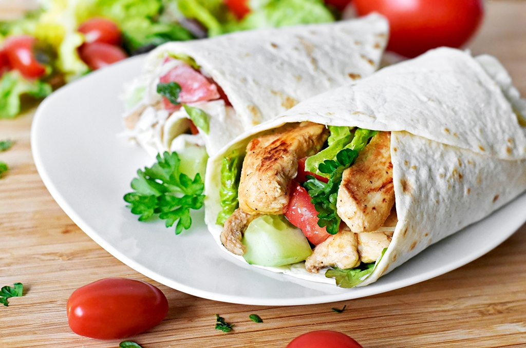 Delicious fresh chicken wrap, closeup shot. Tasty tortilla with Kansas City micro markets and vending machine solutions