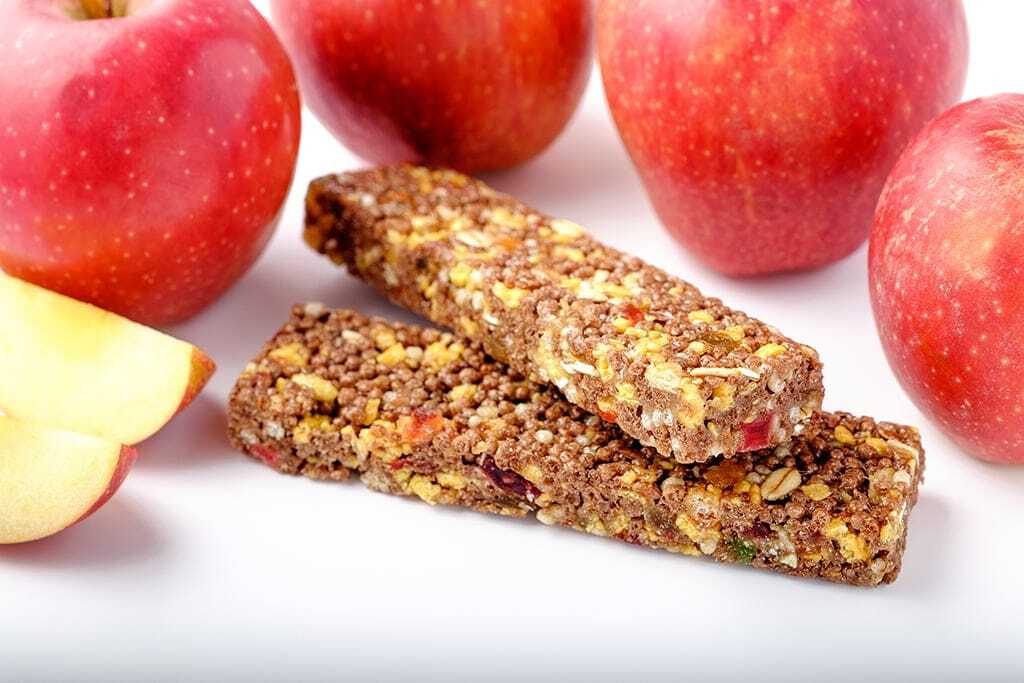 brown granola bars on red apples background San Diego office pantry service and healthy vending service