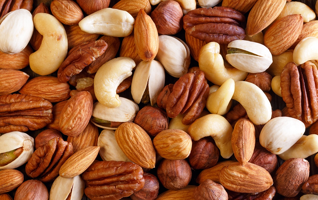 Background texture of assorted mixed nuts including cashew, peca Virginia Beach office pantry service and healthy vending service