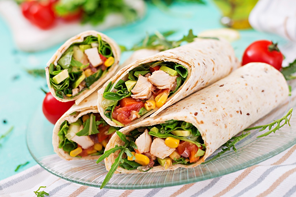 Burritos wraps with chicken and vegetables on light background. micro markets and food vending machines in Lexington