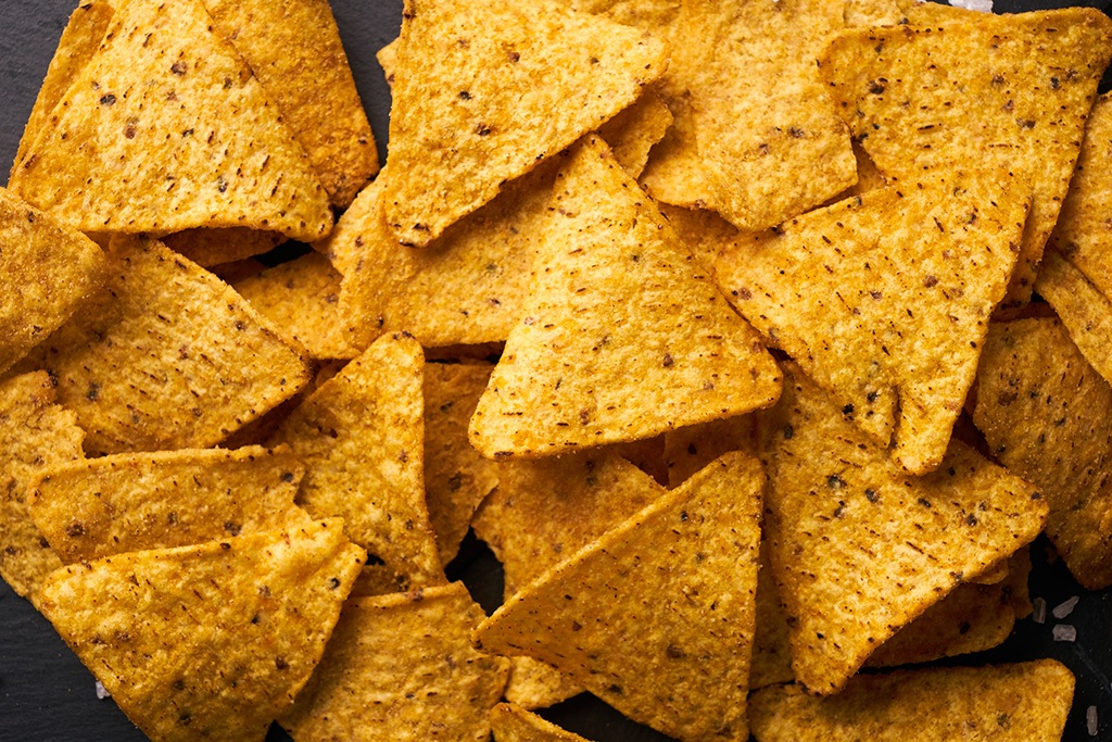 Triangular corn chips nachos background healthy vending machines and water filtration service in Santa Ana