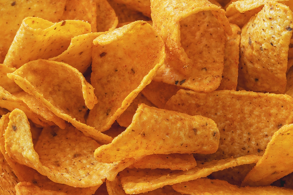 Close-up of a stack of cheese-flavored corn chips Fresno vending service and water filtration