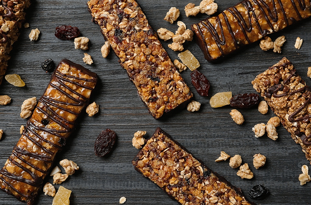 Healthy granola bars on black wooden table, flat lay office pantry service and healthy vending service in Tulsa